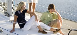 Family sitting on a sail boat in resort wear