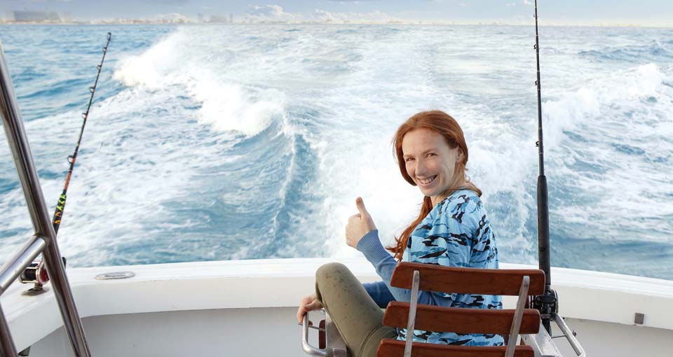 Woman fishing on a boat.